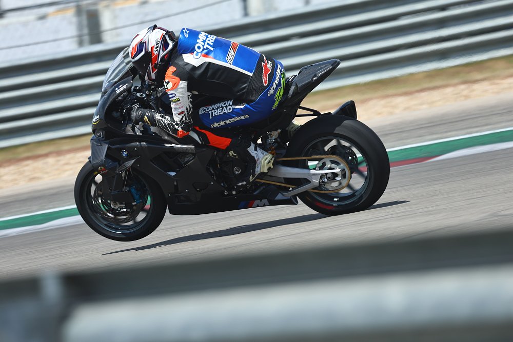 A 2025 alpha Racing M 1000 RR wheelies out of Turn 11 at Circuit of the Americas in Austin, Texas.