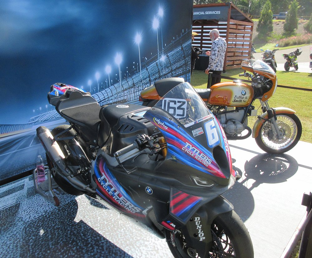 display of the 2025 BMW championship winning bike in the foreground and the 1976 winning bike in the background