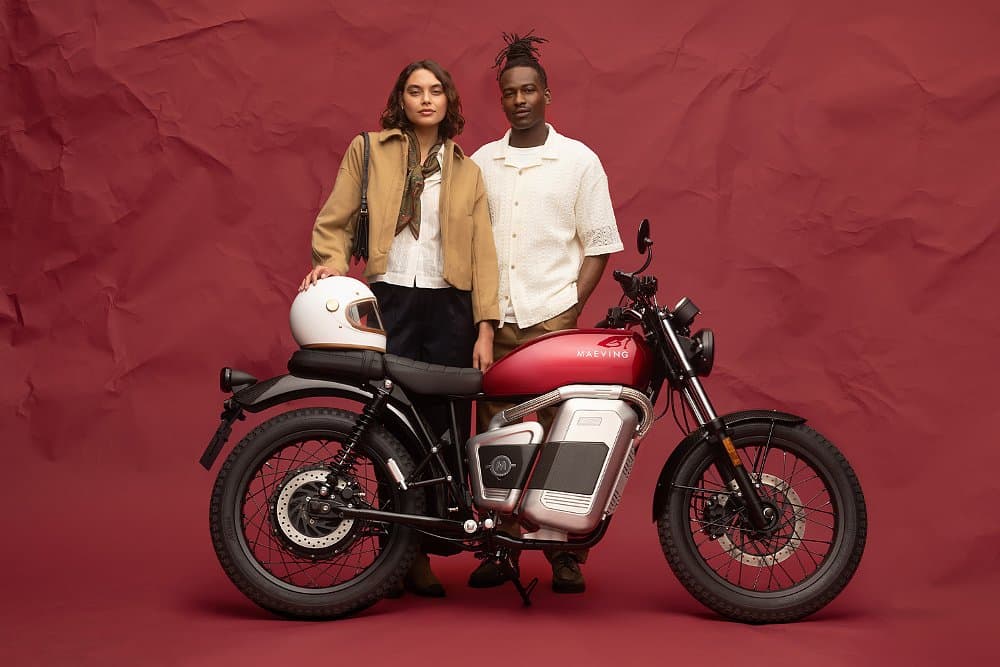 Male and female models stand next to the 2026 Maeving RM2.